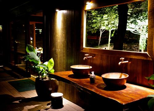 two sinks on a wooden counter in a bathroom at Pousada do Vale in Fernando de Noronha