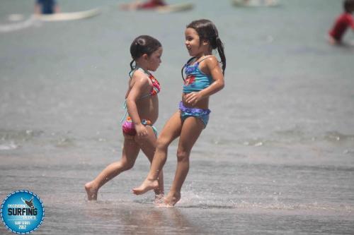 two little girls are walking on the beach at The Blue House Panama in Chame