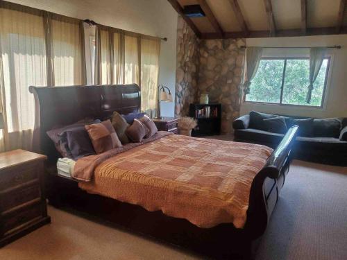 a bedroom with a large bed and a couch at Alta Peak Vista in Three Rivers