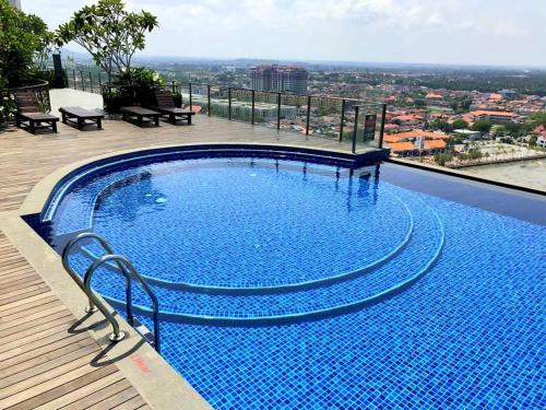 a large swimming pool on top of a building at Silverscape Residence Melaka in Melaka