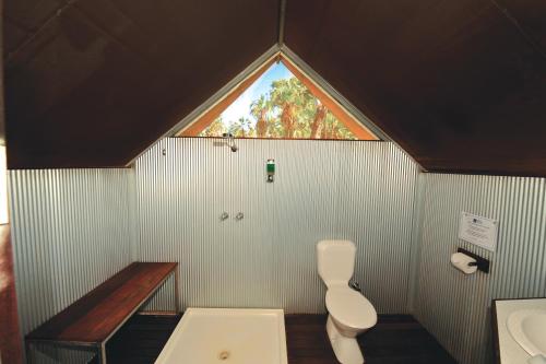 
a bathroom with a toilet and a sink at Mitchell Falls Wilderness Lodge in Camp Creek
