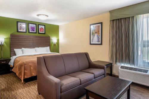a hotel room with a bed and a couch at Quality Inn & Suites Brandenburg - Fort Knox in Brandenburg