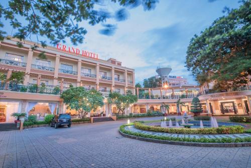 a large building with a fountain in front of it at Grand Hotel Vung Tau in Vung Tau