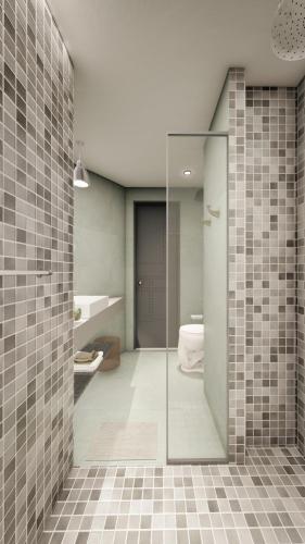 a bathroom with a shower with a glass door at Bridges Danang Boutique Hotel in Danang