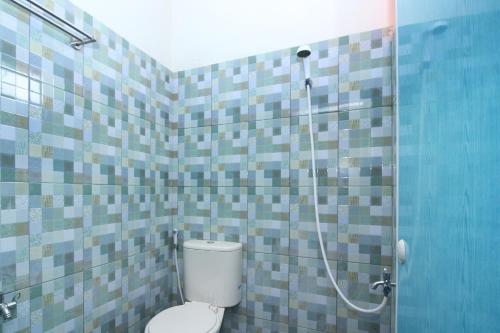 a bathroom with a toilet and a shower at RedDoorz @ Jalan STM Medan in Medan