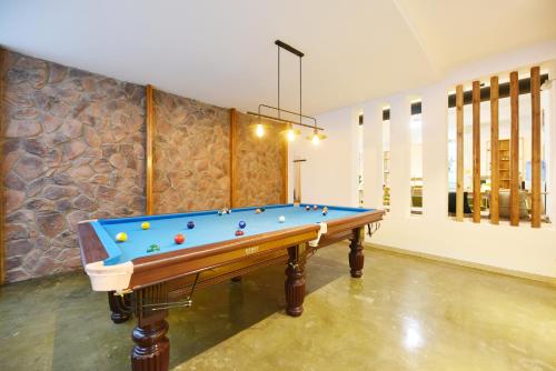 a pool table with balls on it in a room at Shang Shan ruo shui 大理上山若水客栈 in Dali