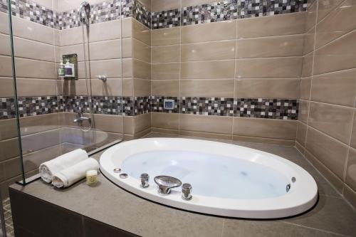 a bathroom with a large tub in a room at Duo Romance Hotel in Hualien City