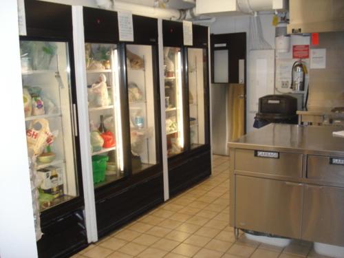 a kitchen with an open refrigerator with food inside at HI Vancouver Downtown - Hostel in Vancouver