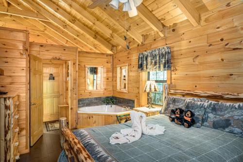 a bedroom with a large bed and a tub at Mosey Bear, Hot Tub, WIFI, 685 FREE tickets each paid day!!! in Sevierville