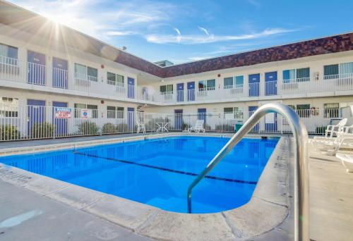 a pool in front of a building with a hotel at Motel 6-Moses Lake, WA in Moses Lake