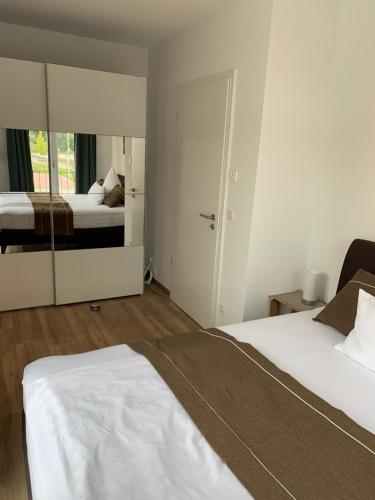 a bedroom with two beds and a mirror at Main Boarding House in Miltenberg