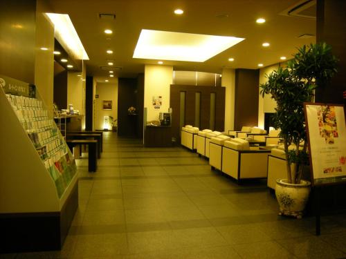 a lobby of a store with couches and a waiting room at Hotel Route-Inn Ashikaga Ekimae in Ashikaga