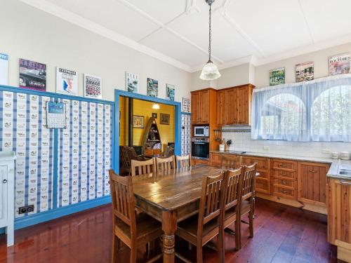 a kitchen with a wooden table and chairs at Beauvais in Port Fairy
