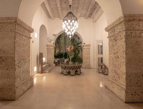 a large hallway with a chandelier in a building at Hotel Noi 1860 Cartagena in Cartagena de Indias