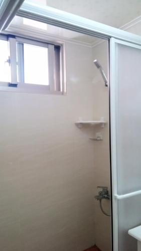 a bathroom with a shower and a window at Smile house Homestay in Taiping