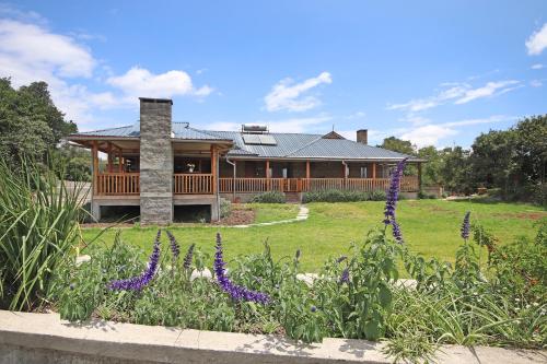 a house with purple flowers in front of it at Olesamara Collection in Nanyuki