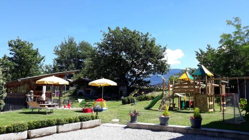 a backyard with a playground with a slide and a play structure at Falgerhof in Vollan