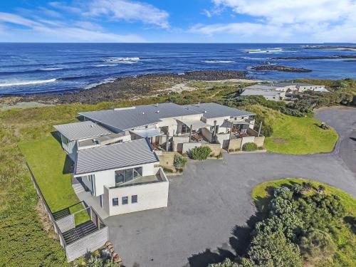 an aerial view of a house with the ocean at Hearns Beachside Villa 1 in Port Fairy