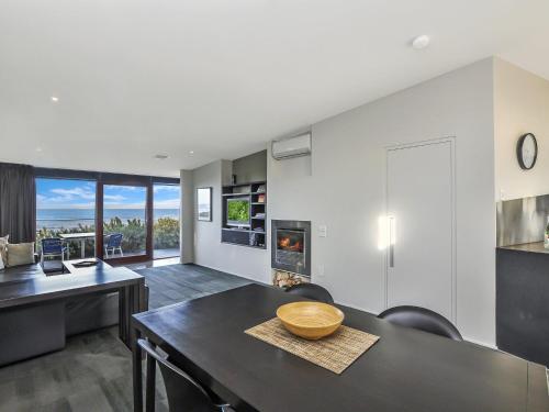 a kitchen and dining room with a table and chairs at Hearns Beachside Villa 1 in Port Fairy