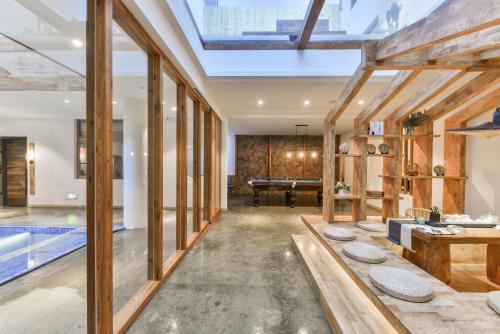 an open living room with a pool and a house at Shang Shan ruo shui 大理上山若水客栈 in Dali