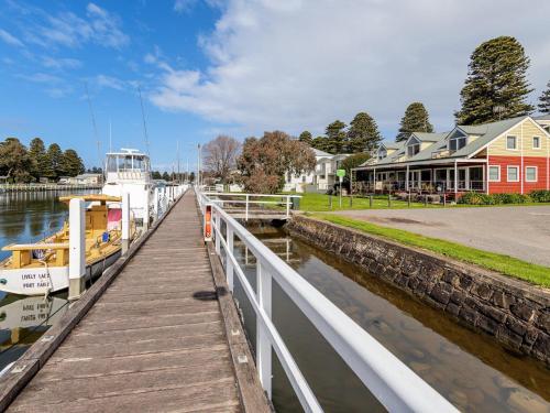 a boat is docked next to a dock at JOHANSSON'S PERCH No. 1 in Port Fairy