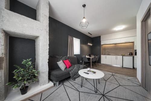 a living room with a couch and a fireplace at Amarant Urban Hotel by CHM in Kyiv