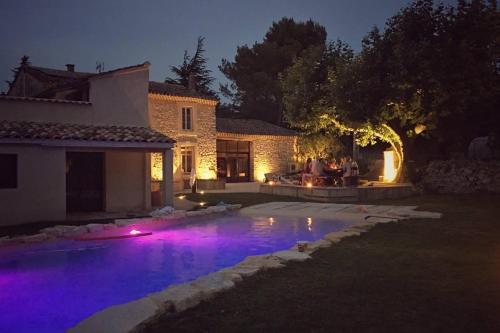 a house with a swimming pool at night at Mas de L Angeos in Velleron