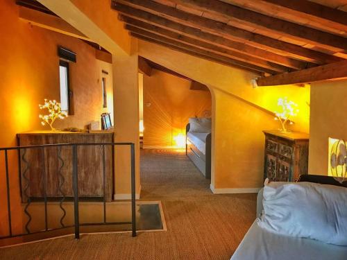 a living room with a bed in a room at Mas de L Angeos in Velleron