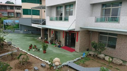 a house with a fake yard in front of it at Smile house Homestay in Taiping
