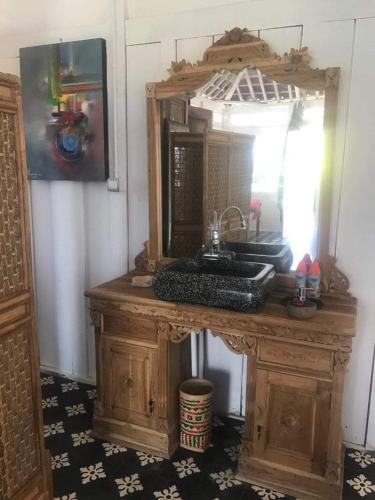 a bathroom with a vanity with a mirror and a sink at Eco dive resort Alycastre in Maumere
