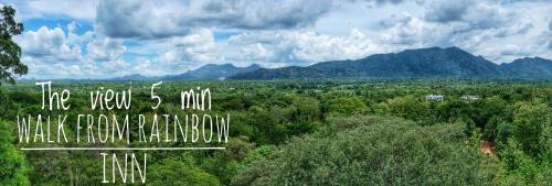an aerial view of a forest with mountains in the background at Golden Rainbow Guest House in Dambulla