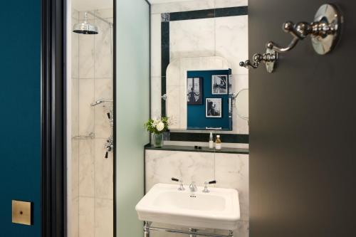 a bathroom with a sink and a mirror at Hôtel Saint Germain in Paris