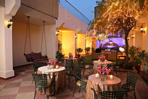 a patio with tables and chairs with candles and lights at Eros Hotel New Delhi, Nehru Place in New Delhi