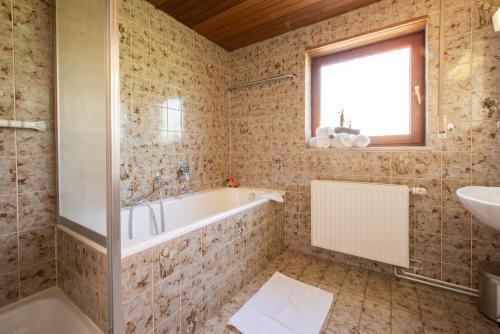 a bathroom with a tub and a sink at FeWo Meersburg in Meersburg