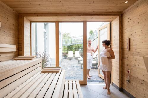 a man and a woman looking out the door of a house at Parkhotel Hachenburg in Hachenburg