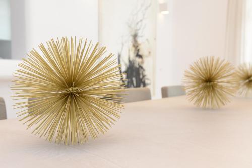 a table with two wooden objects on top of it at Diles Villas & Suites Mykonos in Tourlos