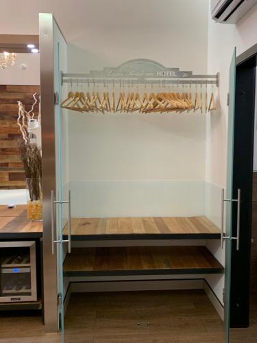 a walk in closet with a shelf with bread at Luna Residence Hotel in Casalmaggiore