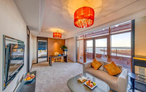 a living room with a couch and a table at Siko Grand Hotel Suzhou Yangcheng in Suzhou