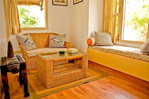 a living room with a couch and a table at Jim's Jungle Retreat in Rāmnagar
