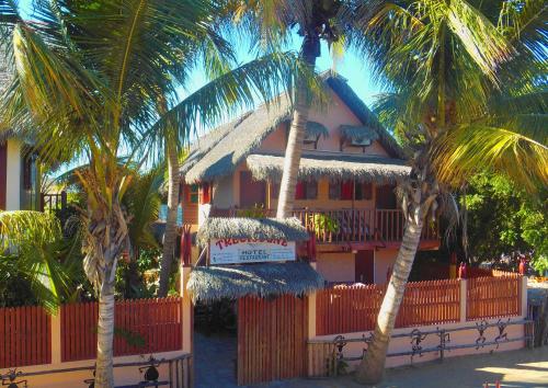 a house with palm trees in front of it at hotel trecicogne in Morondava