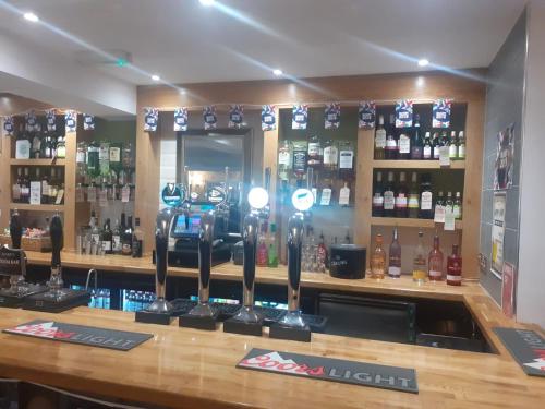 a bar with a lot of bottles of alcohol at The Saltley Inn in Birmingham