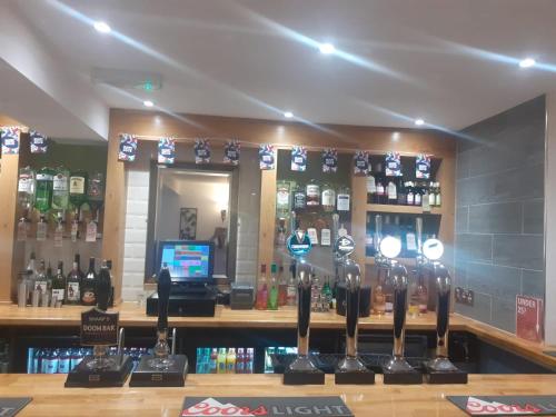 a bar with a lot of bottles of alcohol at The Saltley Inn in Birmingham