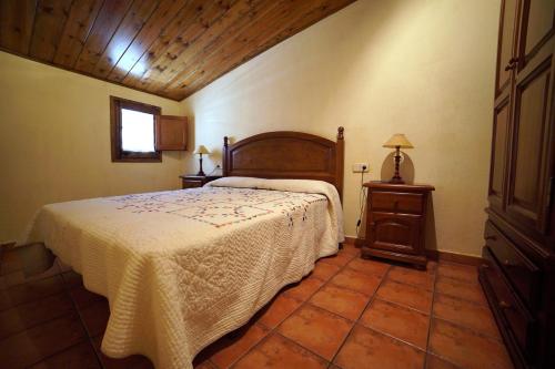 a bedroom with a bed and a table and a window at El carrero in Abella