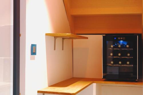 a kitchen with a refrigerator and a black oven at Maison jardin pétanque, MEETT, Airbus, aéroport, golf in Beauzelle
