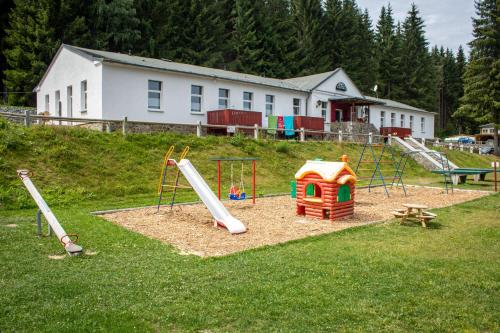 a playground with a slide and a play structure at Erzgebirgsidyll Breitenbrunn Ferienwohnung in Breitenbrunn