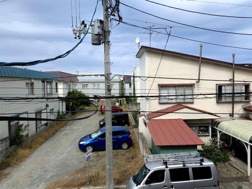 a car parked in a parking lot next to a building at Big Stone Tsukuda 45平米 2SDbed 2For3F in Aomori