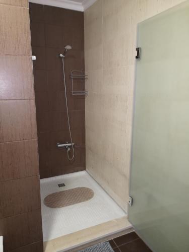 a shower with a glass door in a bathroom at Villa Arade Ferragudo in Ferragudo