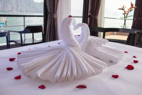two swans shaped like swans sitting on a table at Scarlet Pearl Cruises - Wonder On Lan Ha Bay in Ha Long
