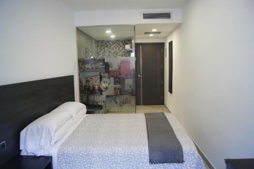 Postel nebo postele na pokoji v ubytování Hostal Sanmar