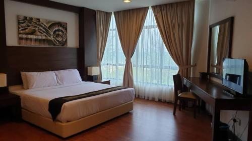 A bed or beds in a room at Samsuria Beach Resort & Residence